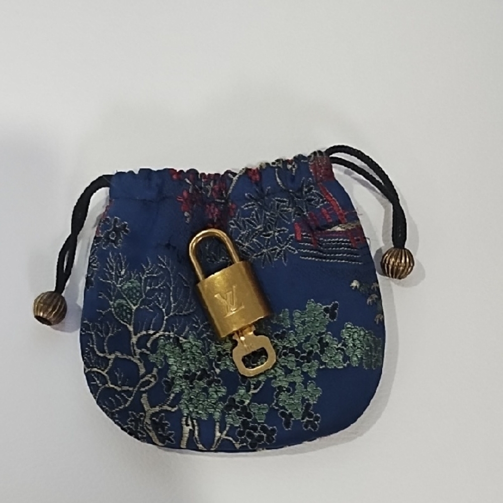 Louis Vuitton Gold Lock And Key With Blue Drawstring Bag. Number 311.